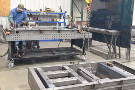 Flextur Welding Table With Man Setting Up to Weld