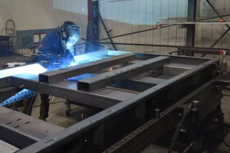 Man Welding Large Project on Flextur Welding Table