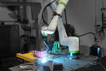 Robotic welding arm operating on Flextur Modular Cobot Welding Table at Chief Industries