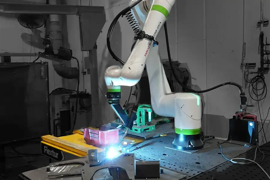 Robotic welding arm operating on Flextur Modular Cobot Welding Table at Chief Industries