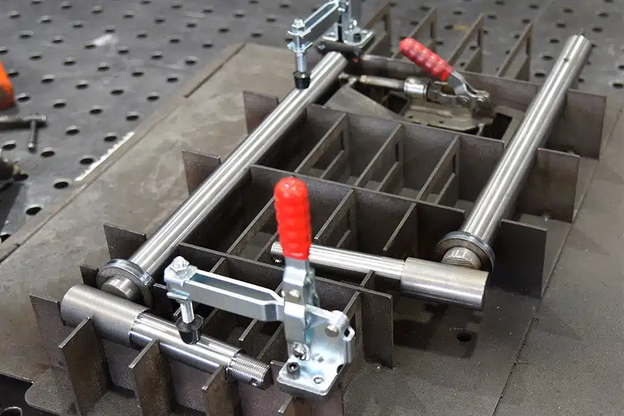 Custom precision welding fixture with toggle clamps and metal tubing secured for fabrication or alignment.